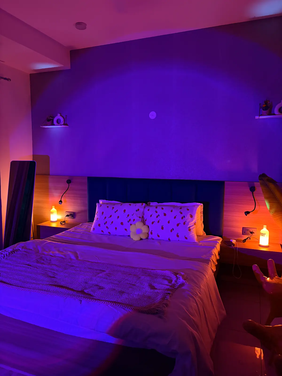 Moody purple lighting over the bed at The Lemon Club boutique stay in Gurgaon
